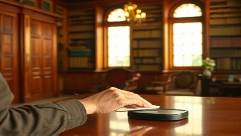 dust-free moveindusting, engrossed, polishing wooden surfaces, photorealistic, elegant library with antique mahogany furniture, highly detailed, sheen on polished wood, textures highlighted, warm browns and yellows, afternoon sun, shot with a 35mm lens.